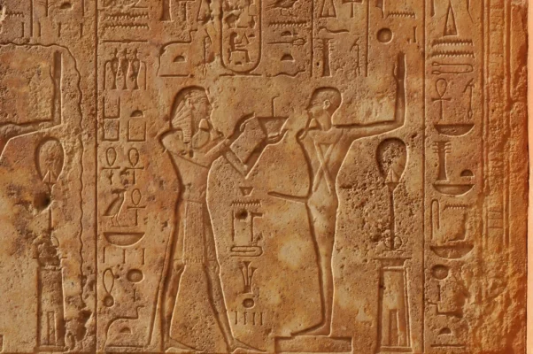 Pharoah-presenting-a-gift-to-the-ithyphallic-god-Min-at-the-great-ancient-Egyptian-temple-of-Amun-at-Karnak-Luxor-in-Egypt